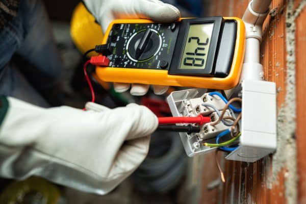 View,From,Above.,Electrician,Worker,At,Work,With,The,Tester